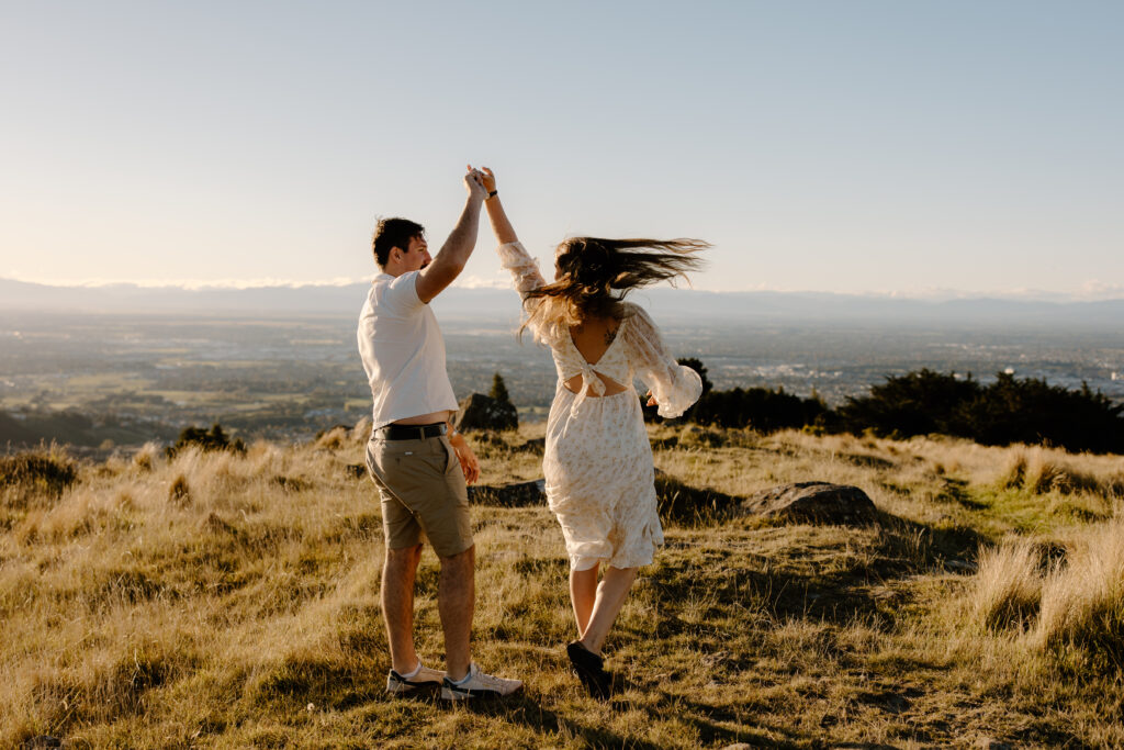 Chasing golden light in The Port Hills Couple in the grass
