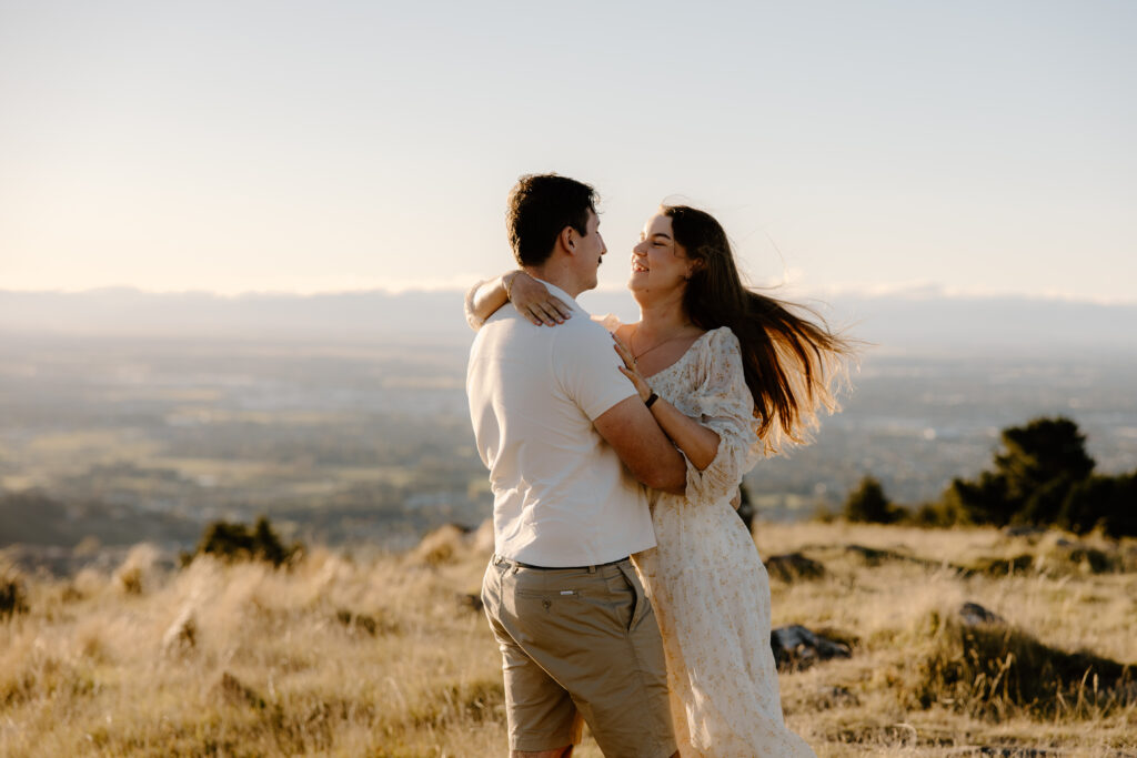Chasing golden light in The Port Hills Couple in the grass