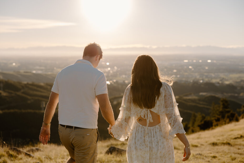 Chasing golden light in The Port Hills Couple in the grass