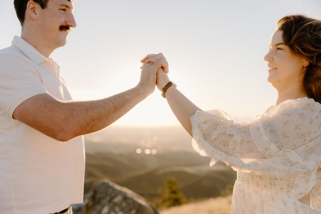 Chasing golden light in The Port Hills Couple in the grass