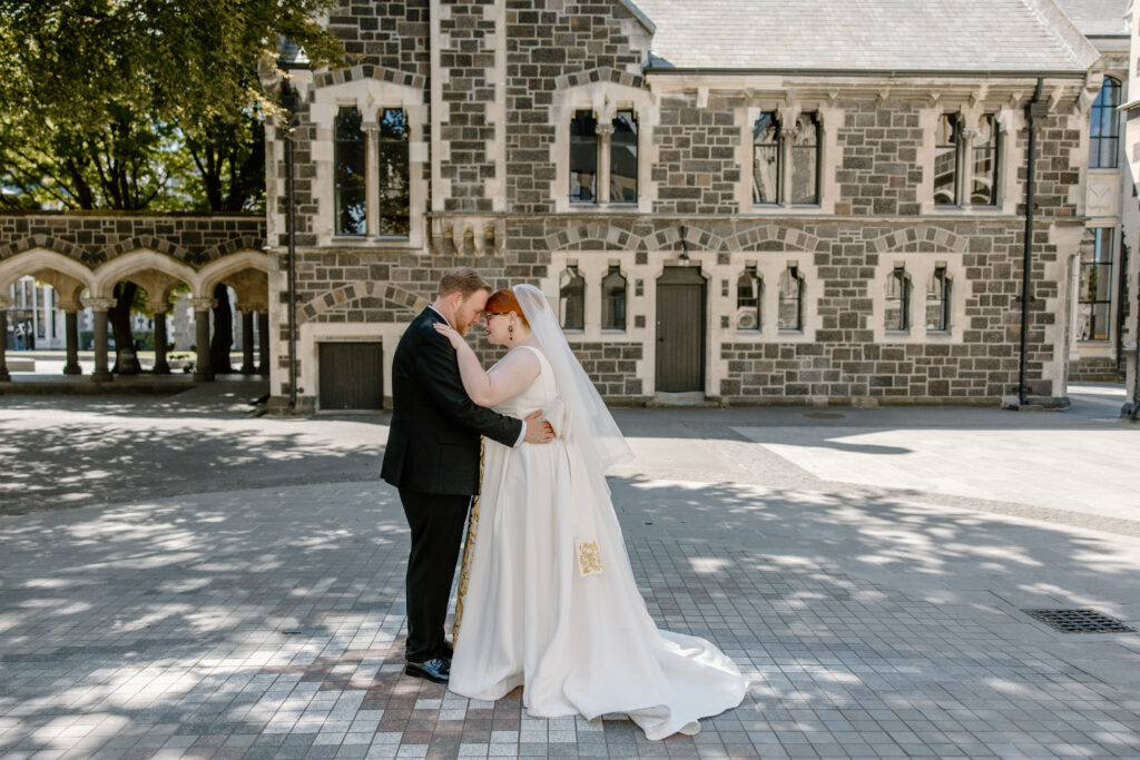 Bride and Groom standing together in The Arts Centre in Christchurch