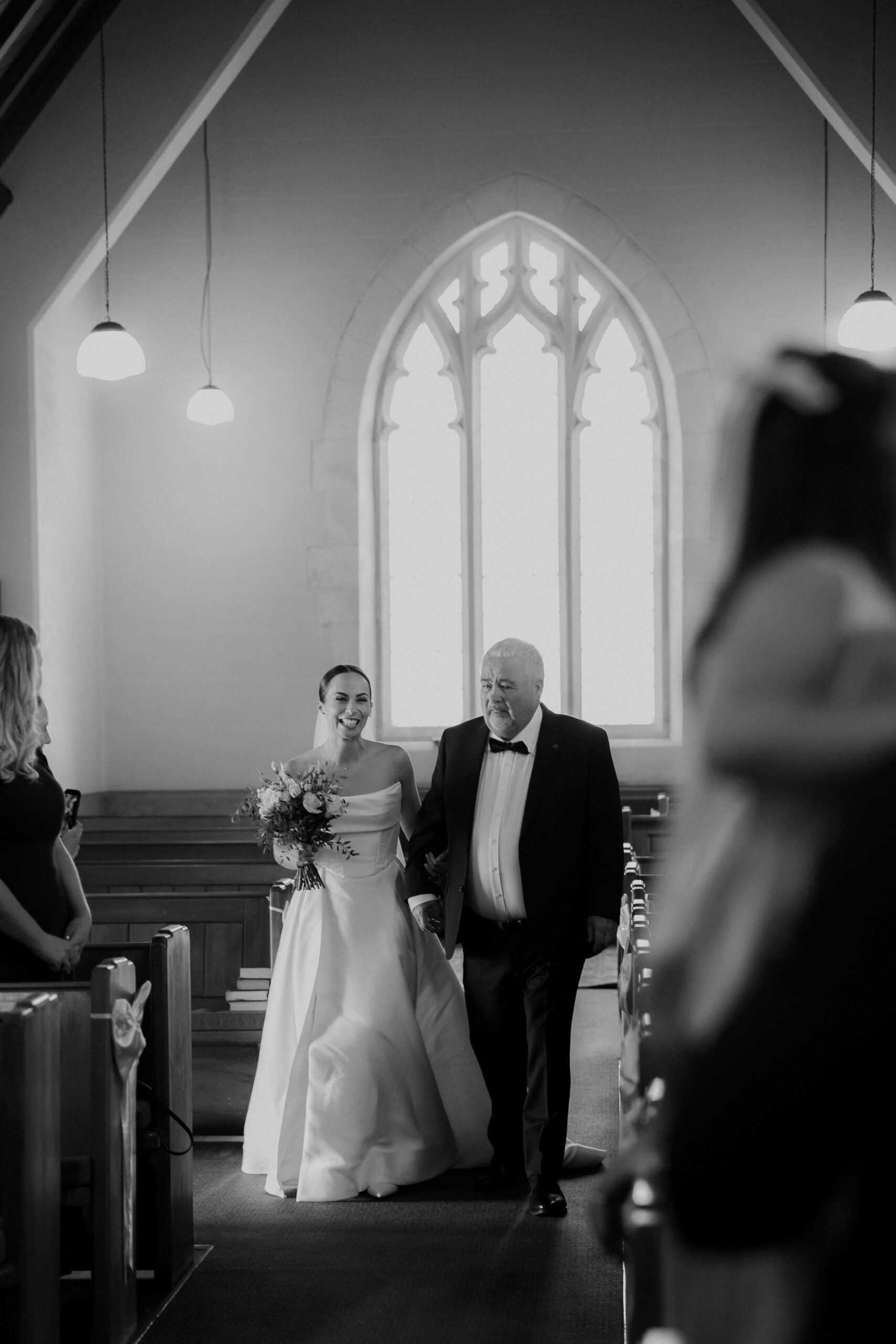 Black and White photo of Bride walking down the aisle