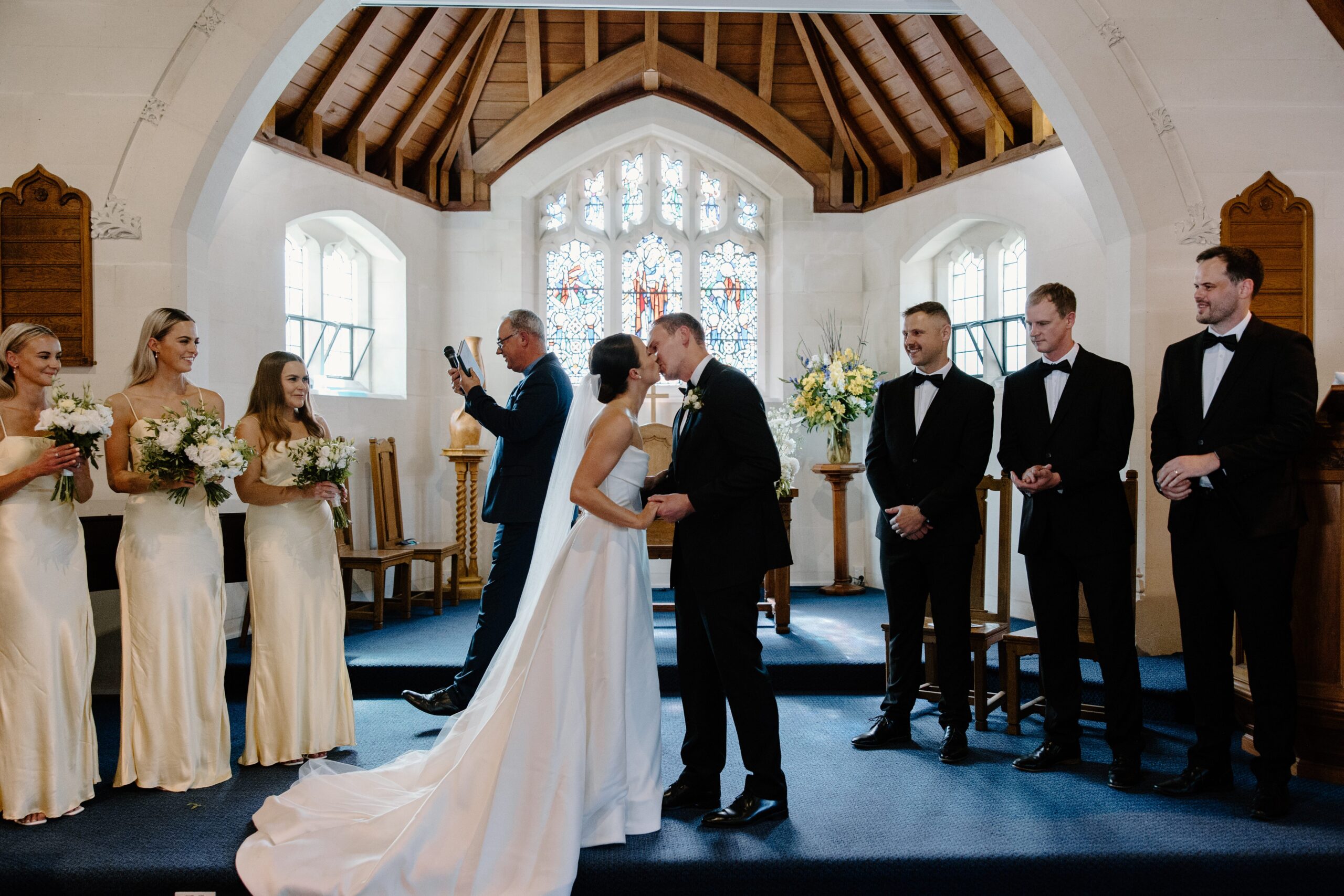 First kiss between bride and groom after a church ceremony