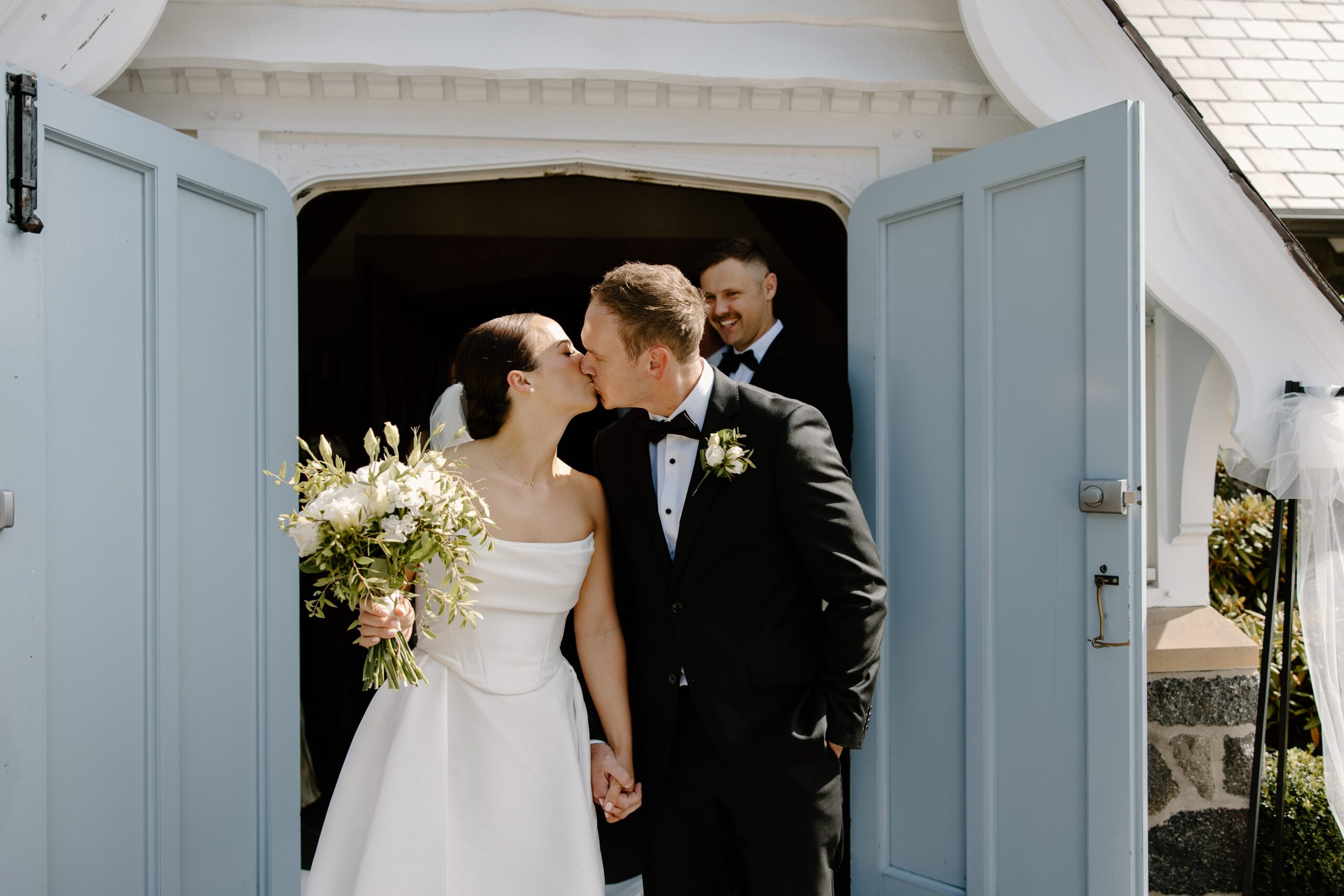 Bride and Groom kiss outside Cashmere Church