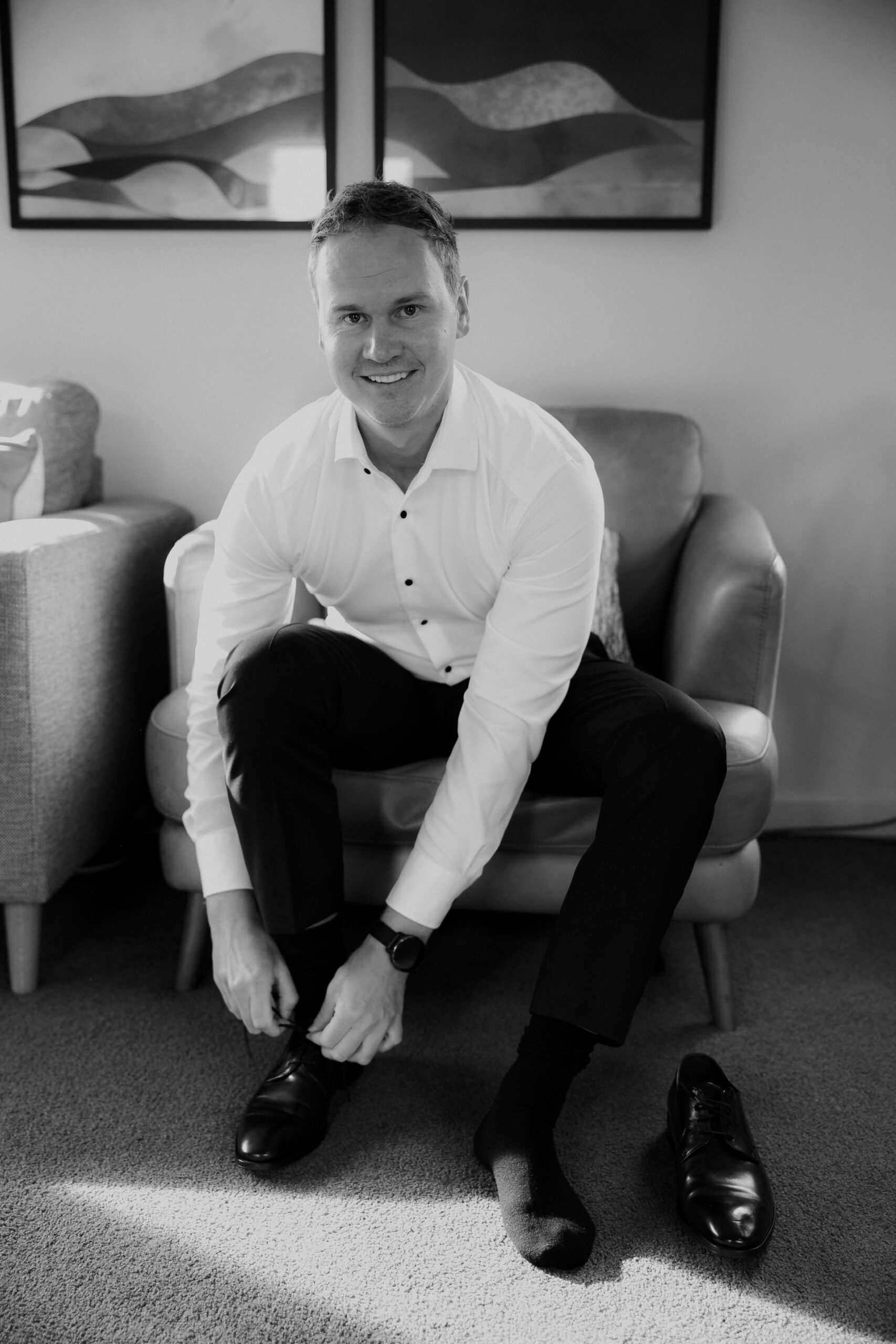 Black and White image of Groom getting ready