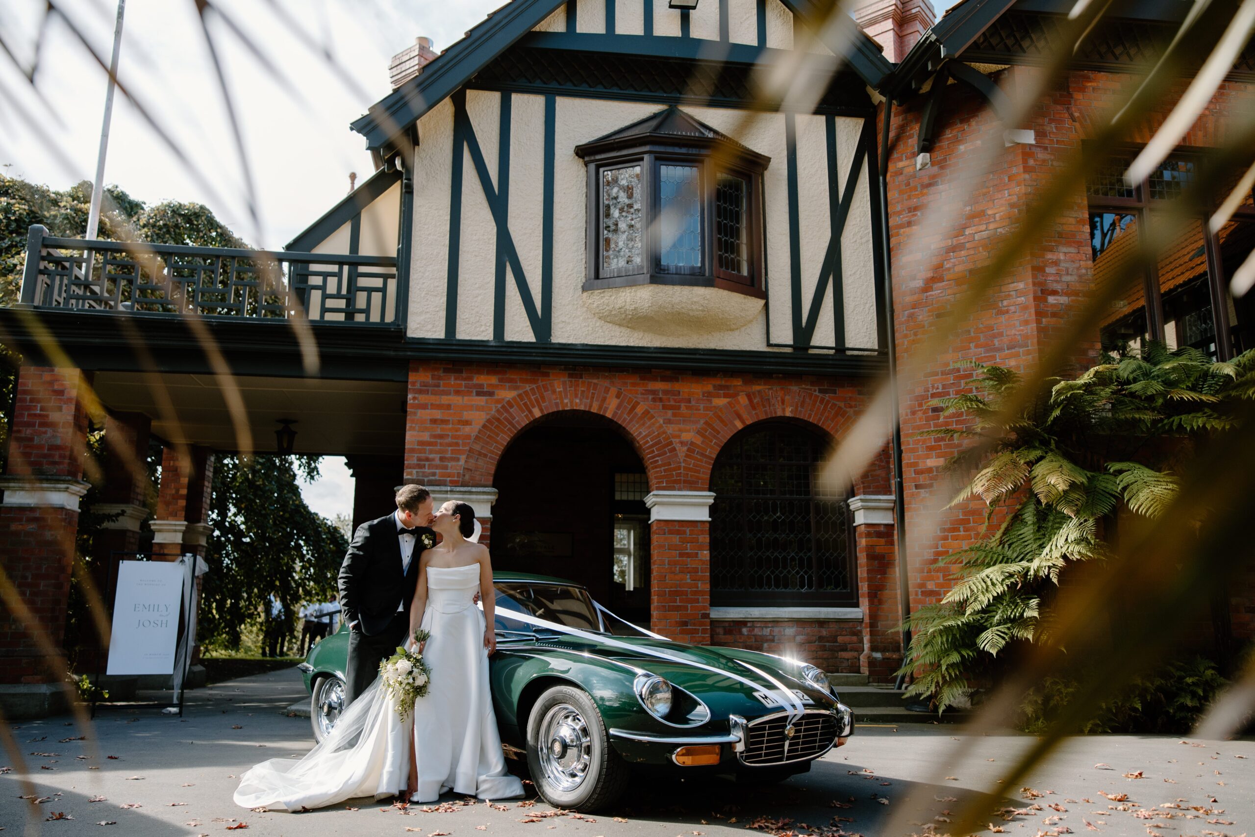 Bride and Groom outside Mona Vale with Green Car