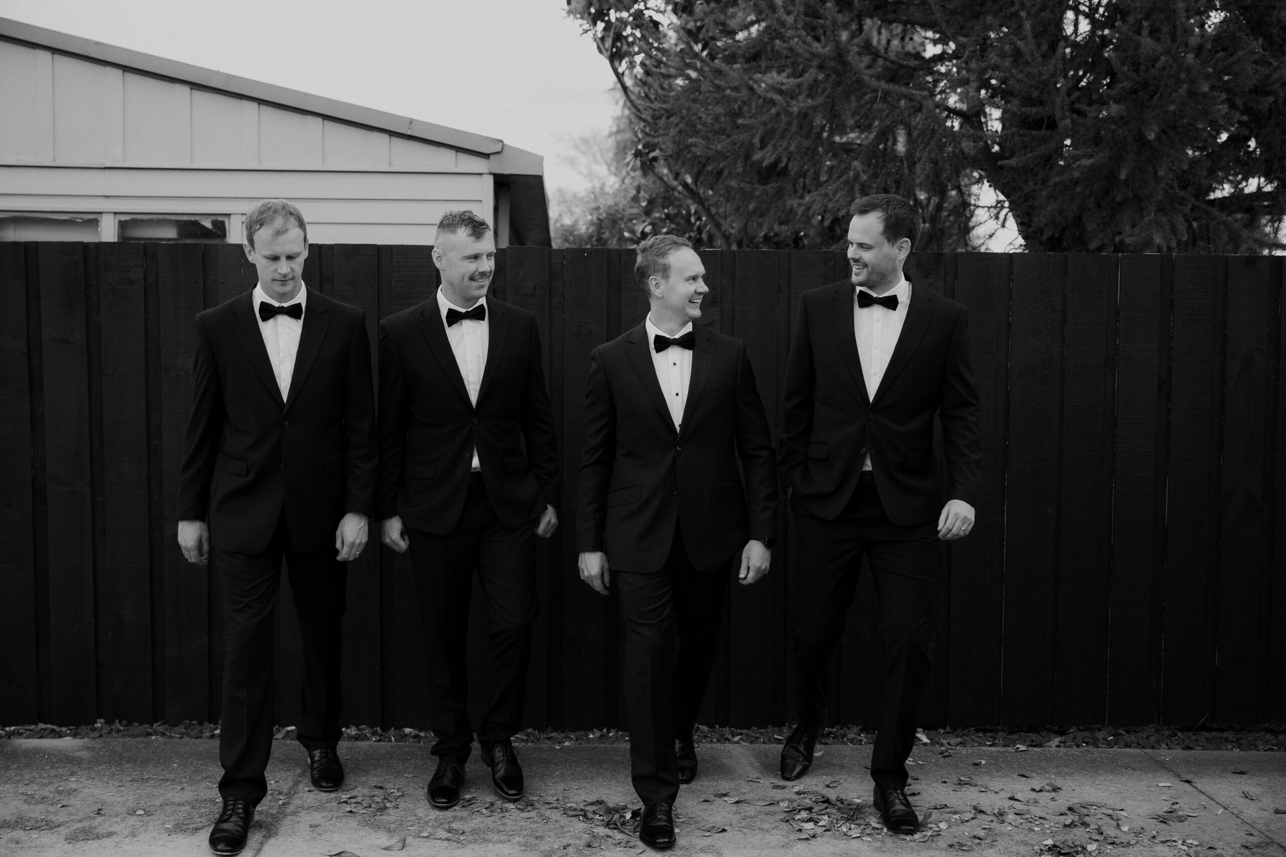 Black and White photo of groom and groomsmen walking