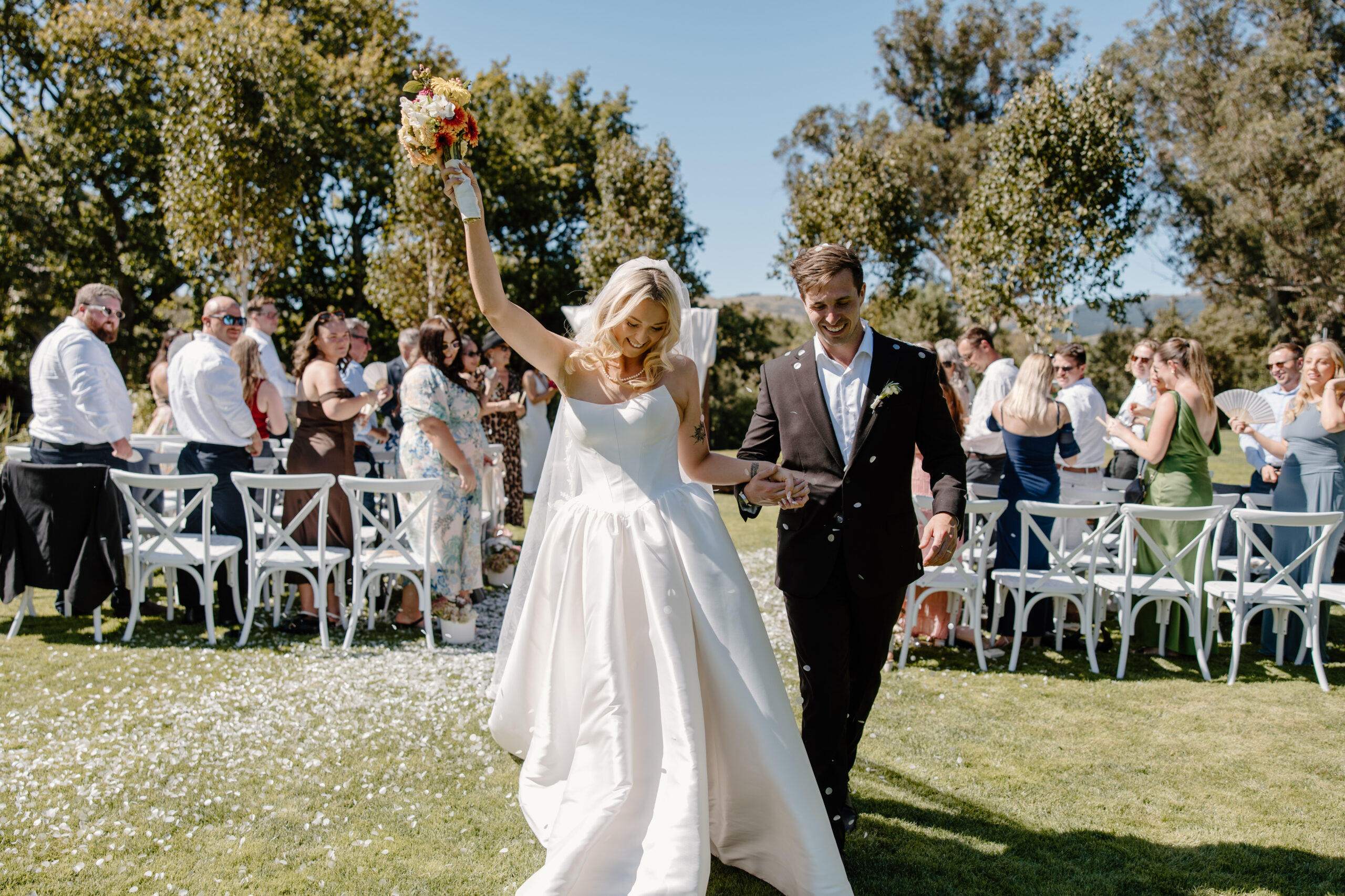Bride and Groom walking back up the aisle at a summer Tai Tapu Hotel wedding near Christchurch.