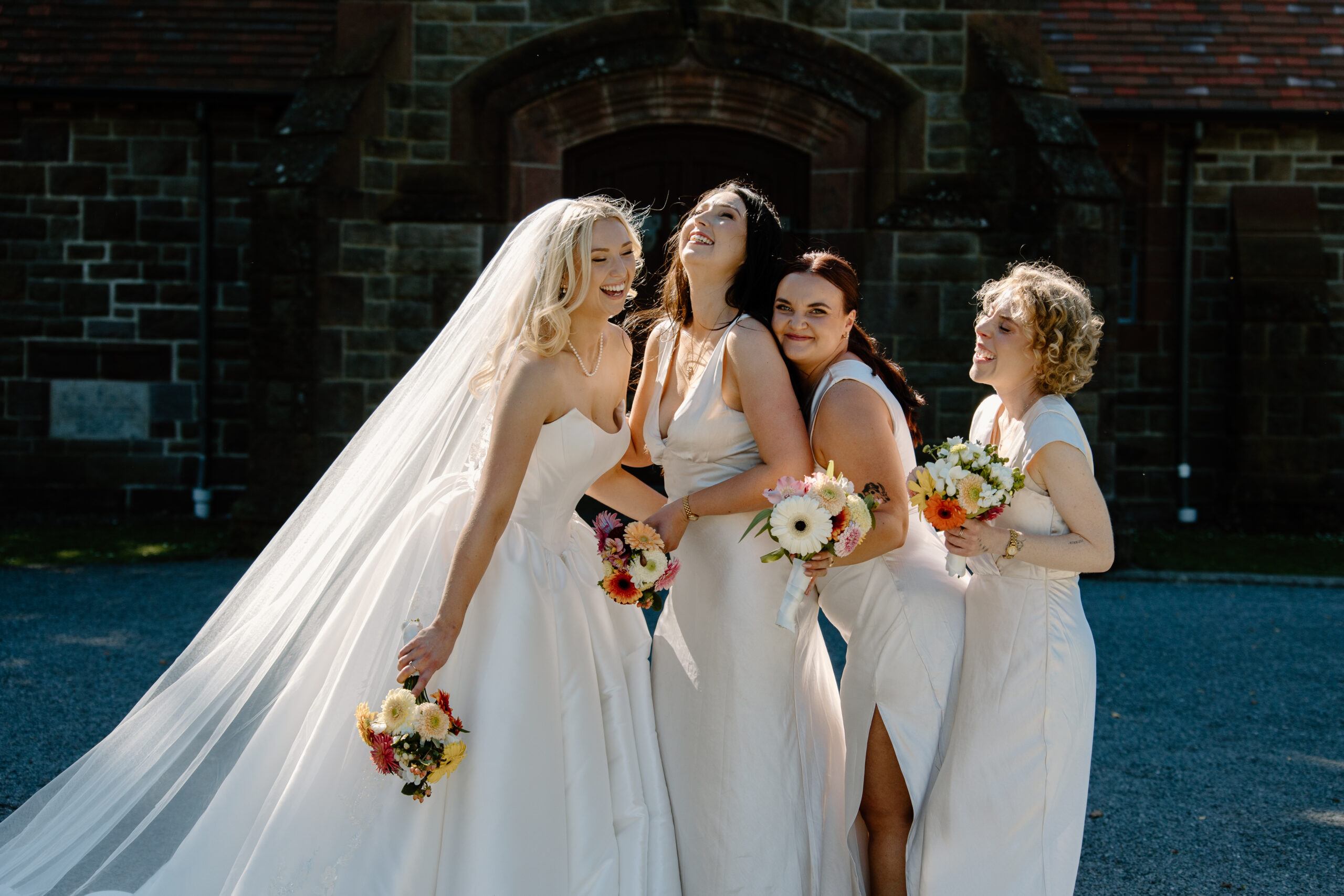 Bride and bridesmaids outside the Church at a summer Tai Tapu Hotel wedding near Christchurch.