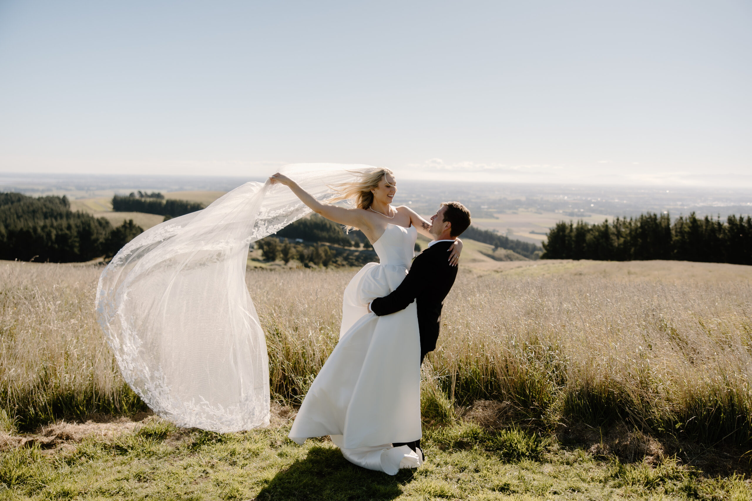 Bride and Groom in the hills at a summer Tai Tapu Hotel wedding near Christchurch.