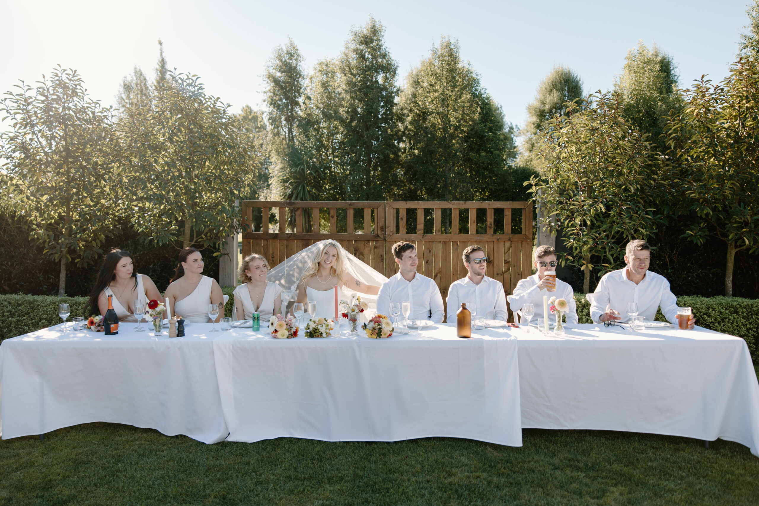 Bridal Party head table al fresco dining at a summer Tai Tapu Hotel wedding near Christchurch.