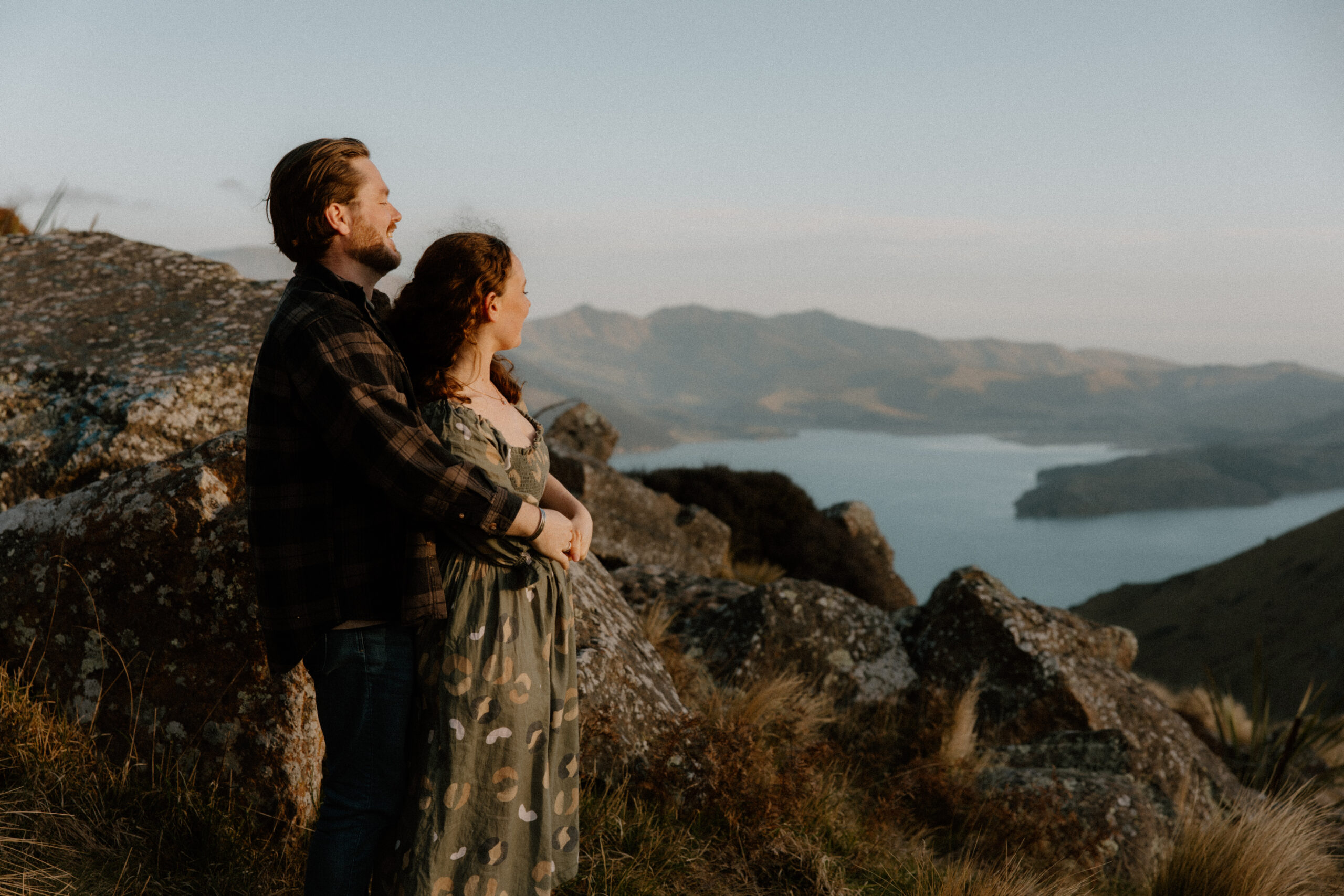 Couple looking out over Lyttleton Harbour during a Port Hills Engagment Session