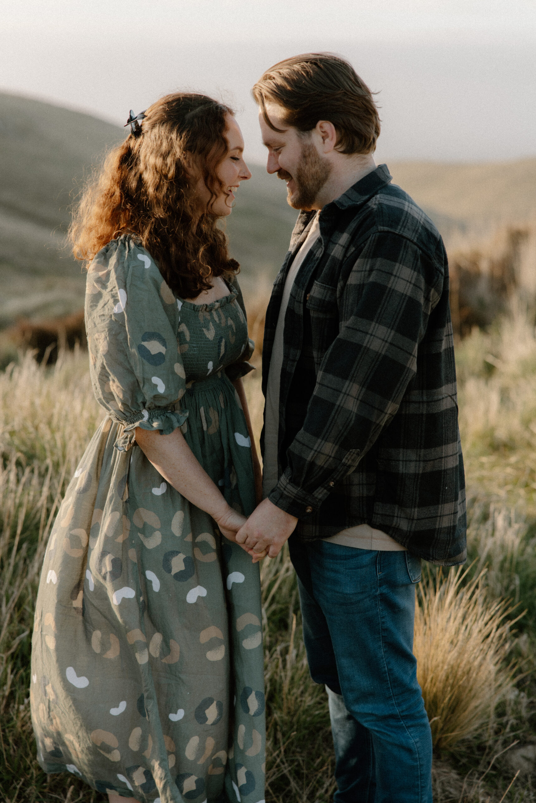 Couple holding hands during an engagement session at Rapaki Rock in the Port Hills, Christchurch.