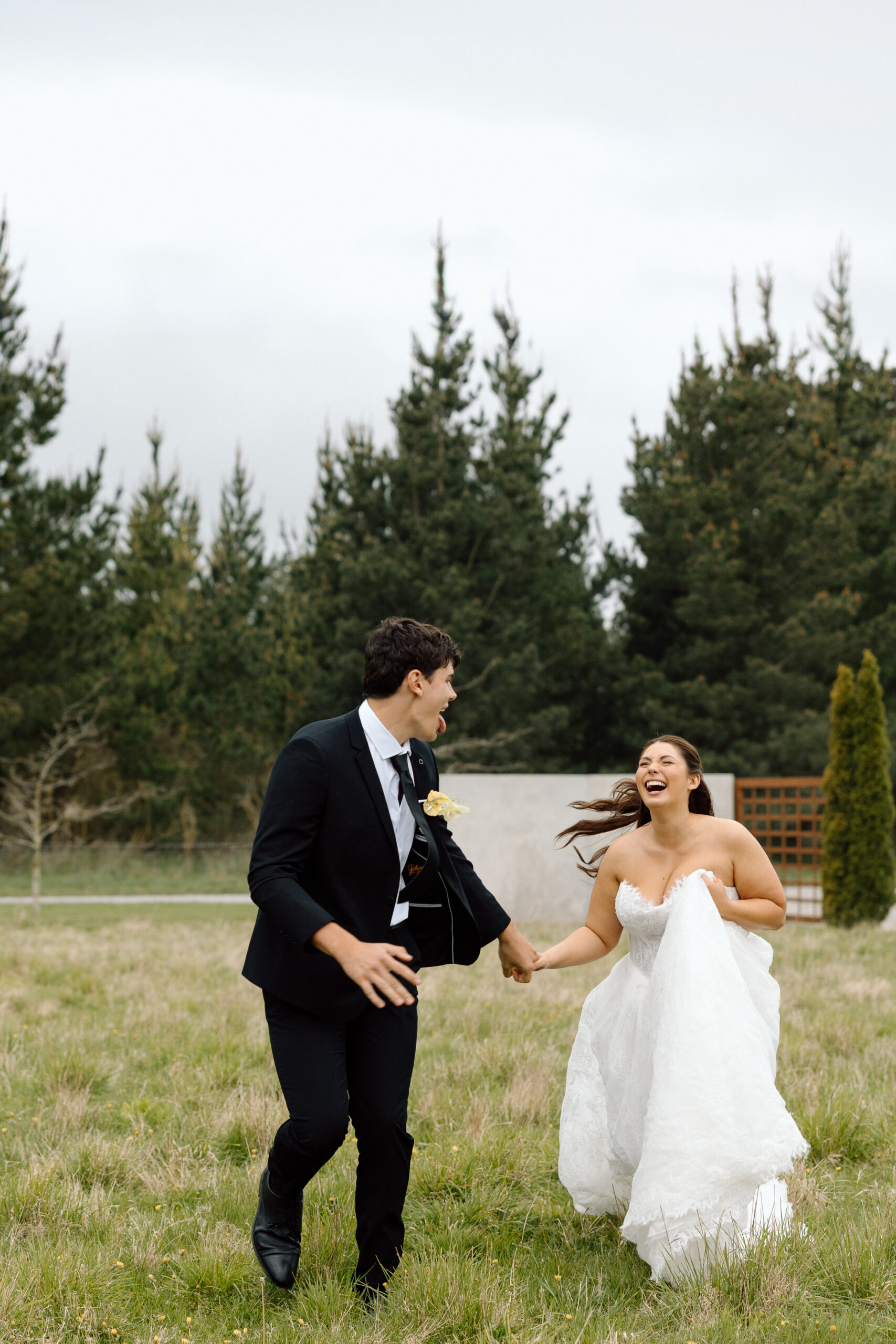 The Flaxmill Bride and Groom running through the grass